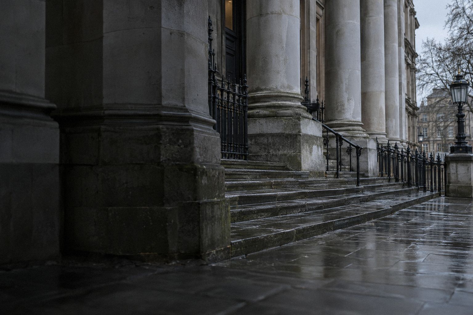The empty steps of a Victorian court building at dawn.