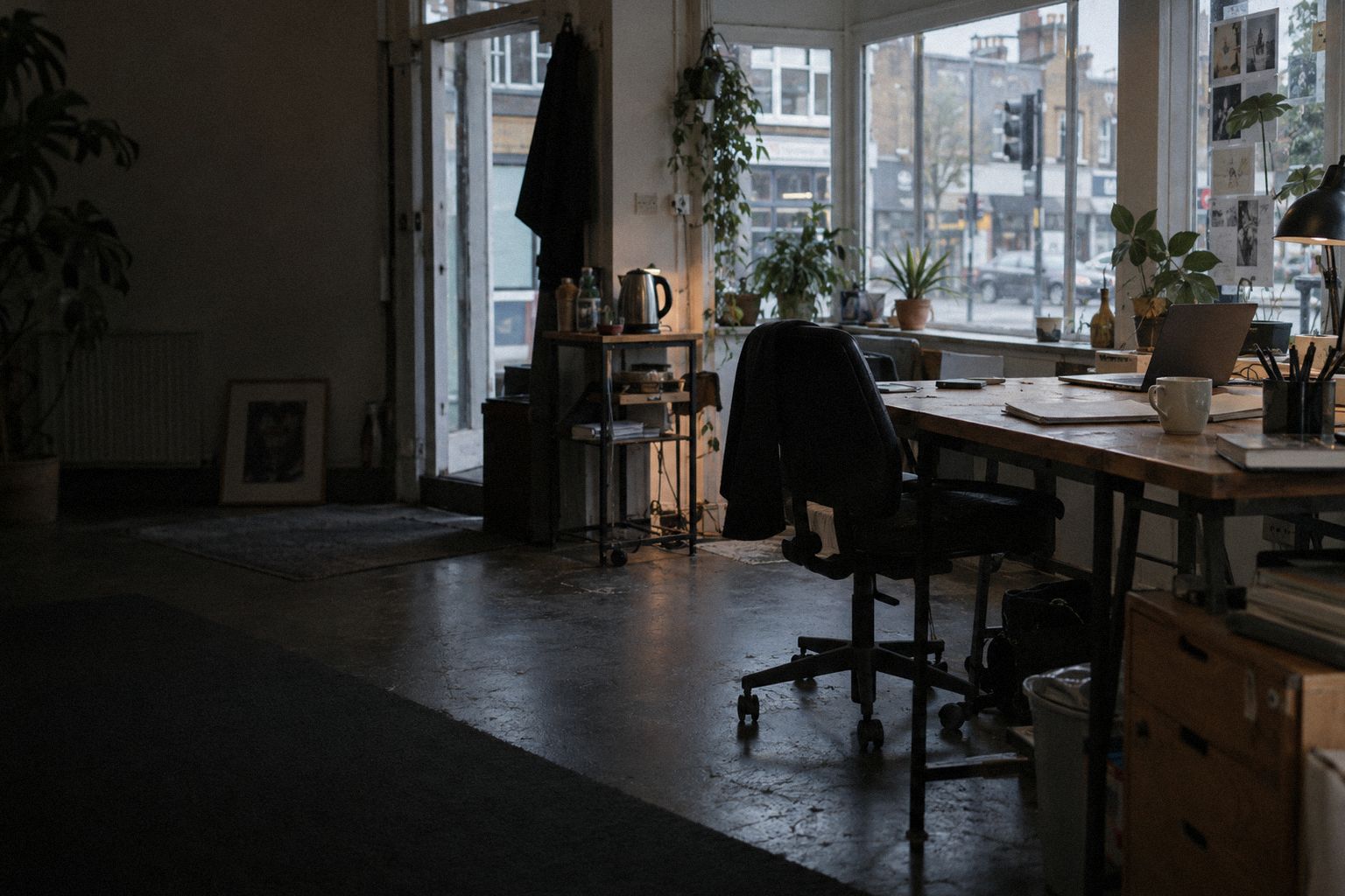 A web studio in a converted shop at 9am, a proposal face down beside a mug.