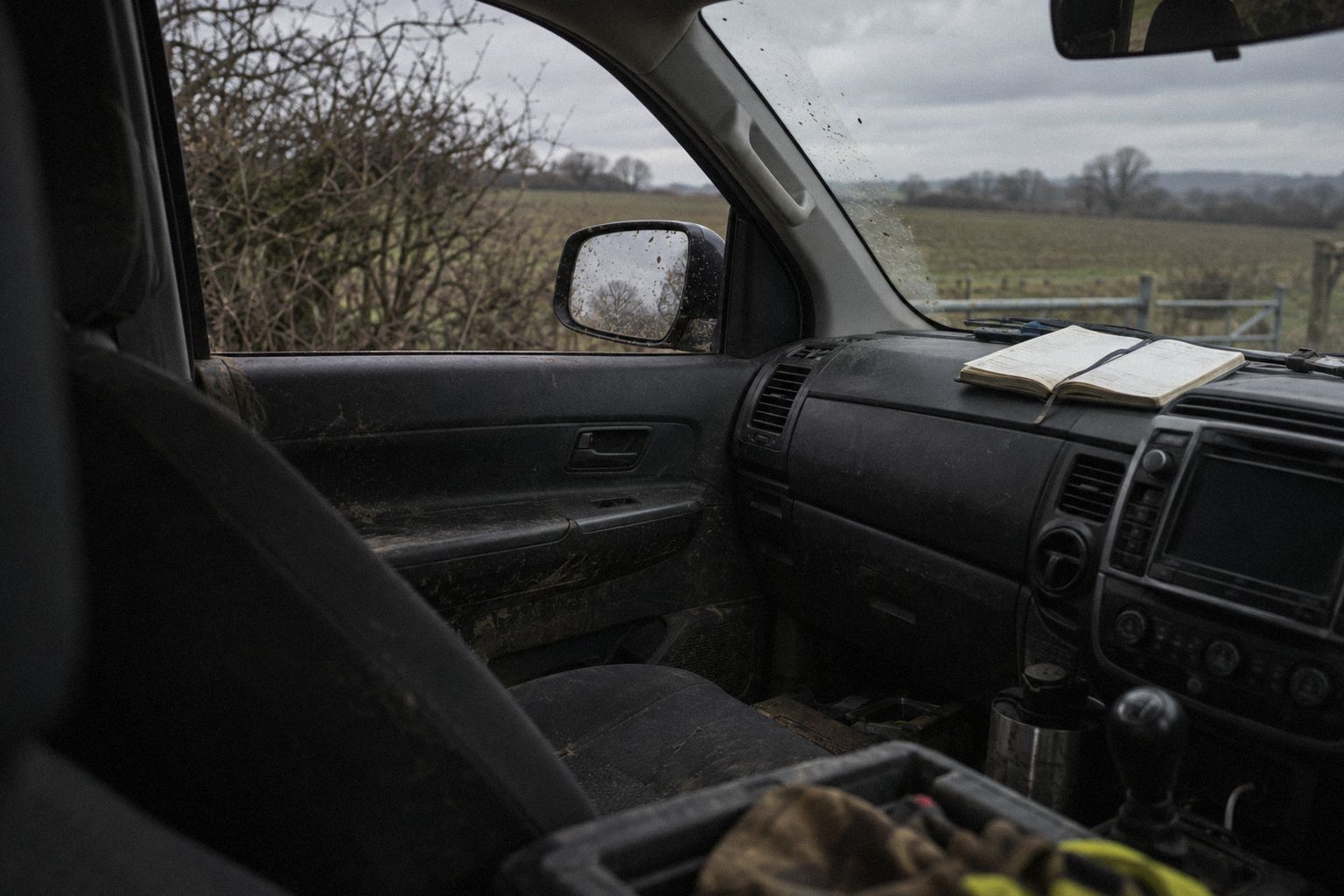 A pickup in a winter lay-by, a pocket diary open on the dashboard.