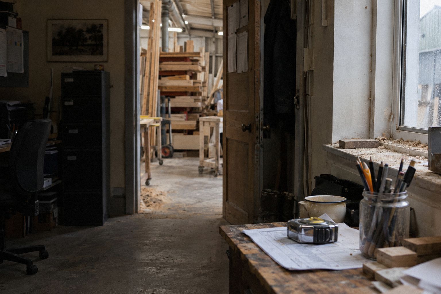 A joiner's office at 4pm, a printed list held down by a tape measure.