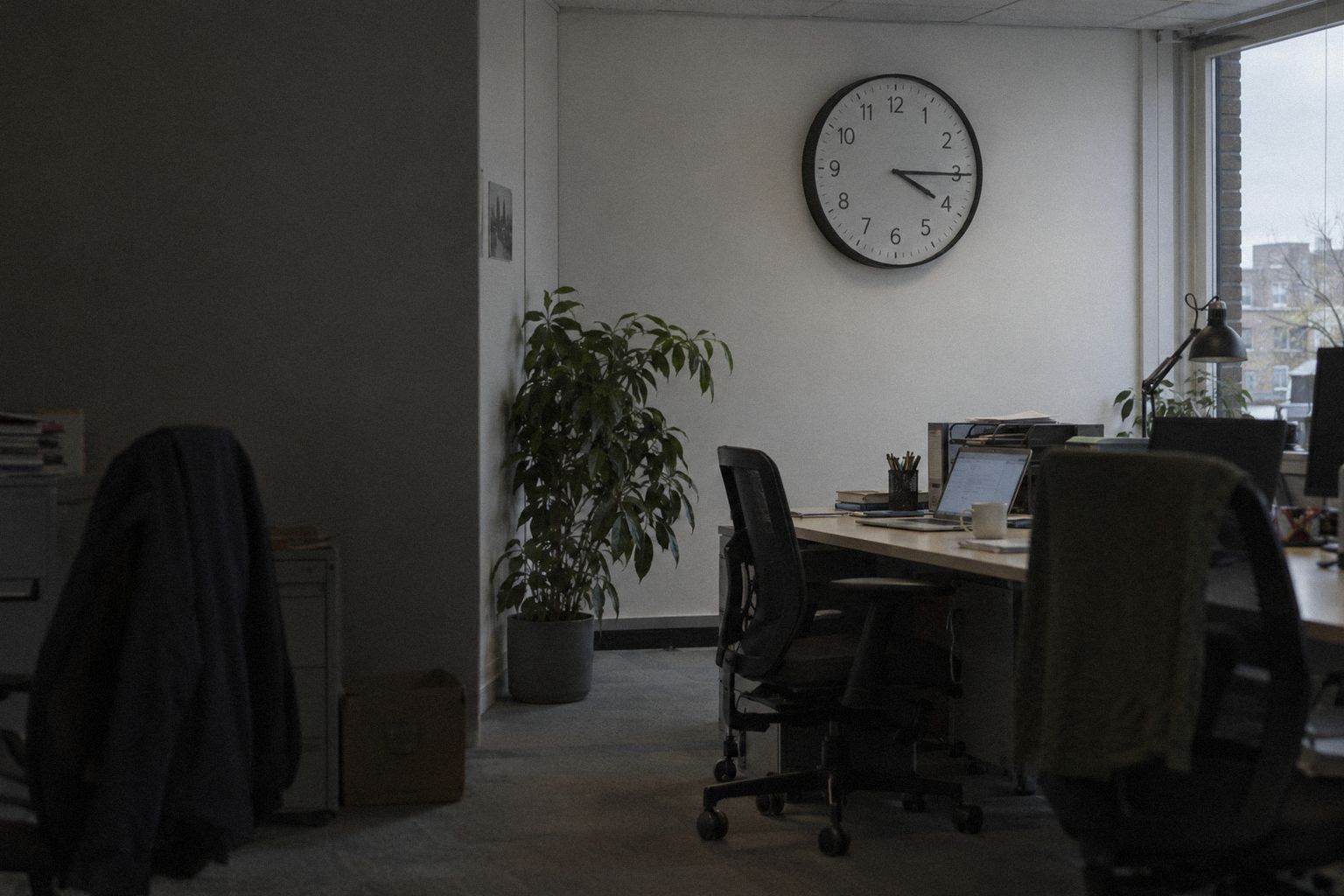 An agency office at 4.15pm, the wall clock nearly at half past.