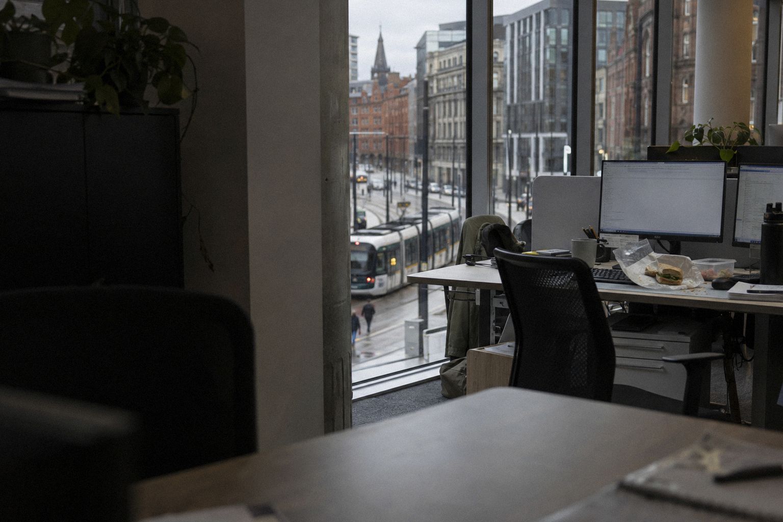 An office at lunchtime, a tram passing in the street below the window.