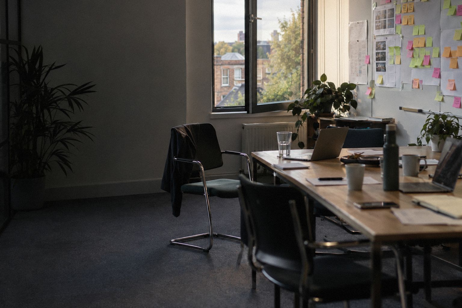 An agency meeting room on a summer Friday, a project board on the wall.
