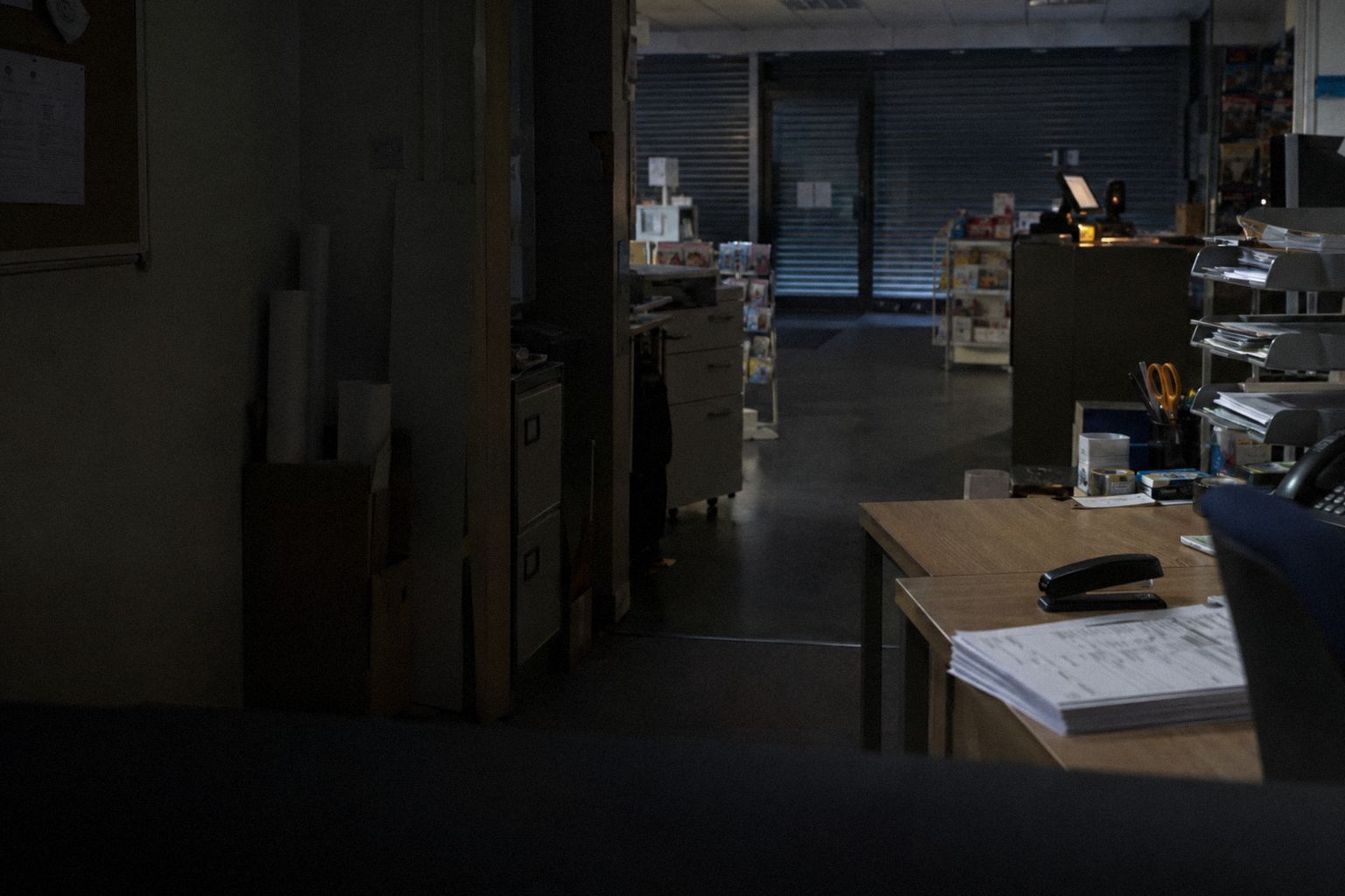 A print shop after closing, a form and a stapler on the desk.